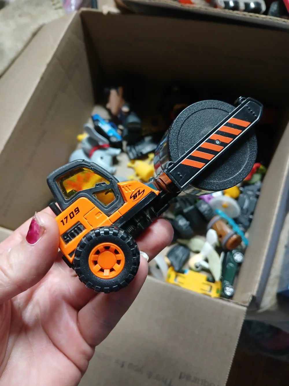 die-cast orange road roller toy Maisto